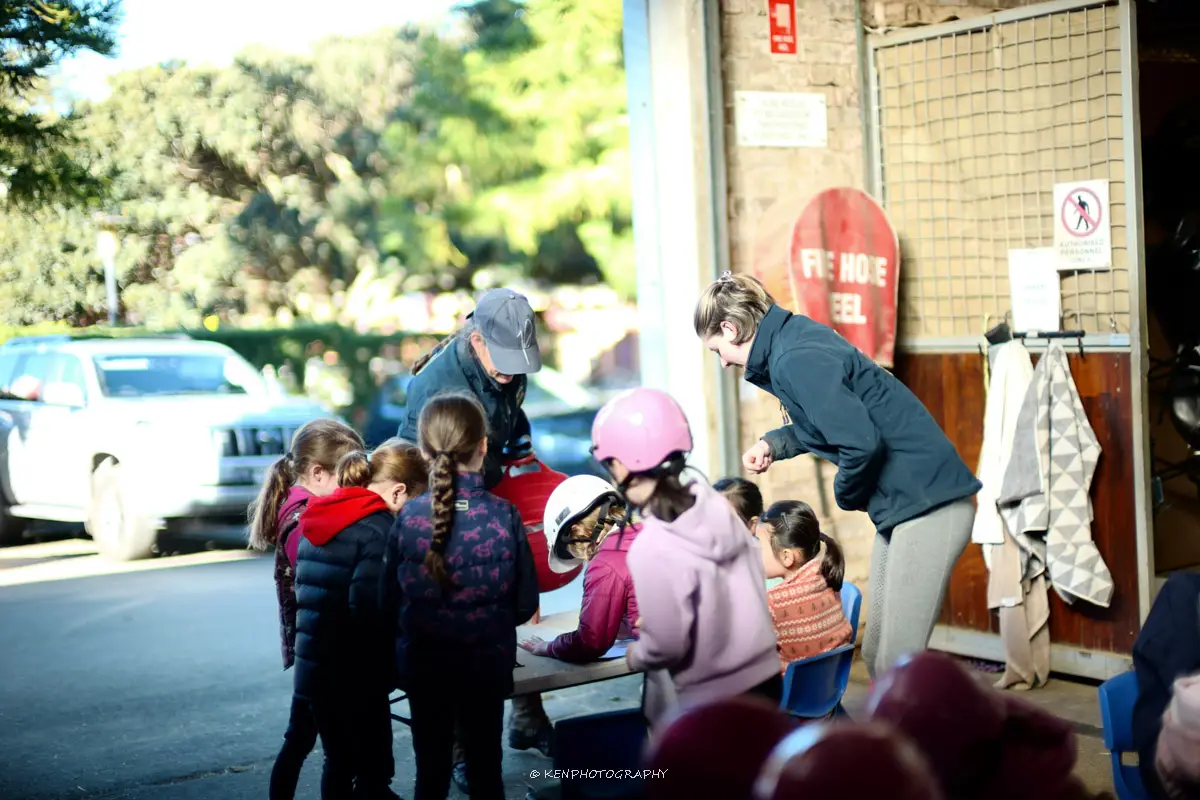 Kids doing stable chores at Eastside Riding Academy school holiday horse program Sydney